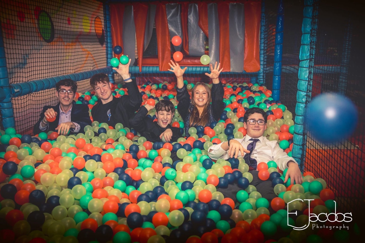 Teenagers throwing balls in the ball pit