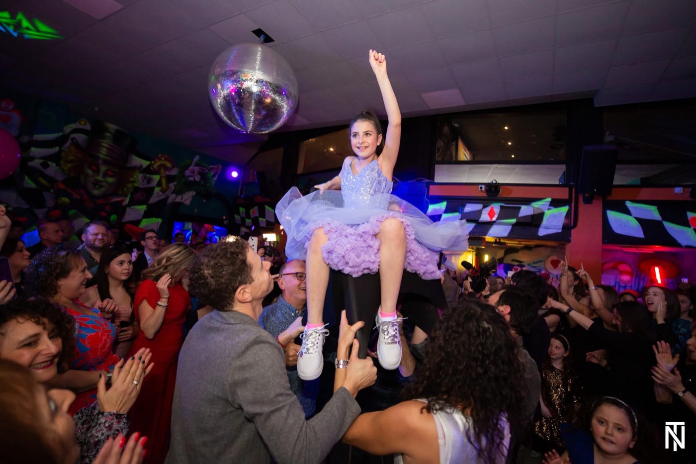 A Bat Mitzvah girl lifted high on a chair