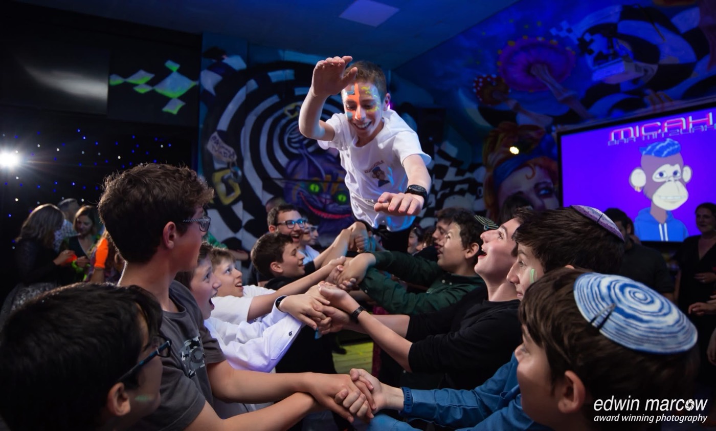 Friends lifting the Bar Mitzvah boy