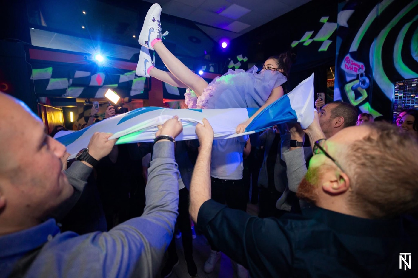 A Bat Mitzvah girl lifted on a flag