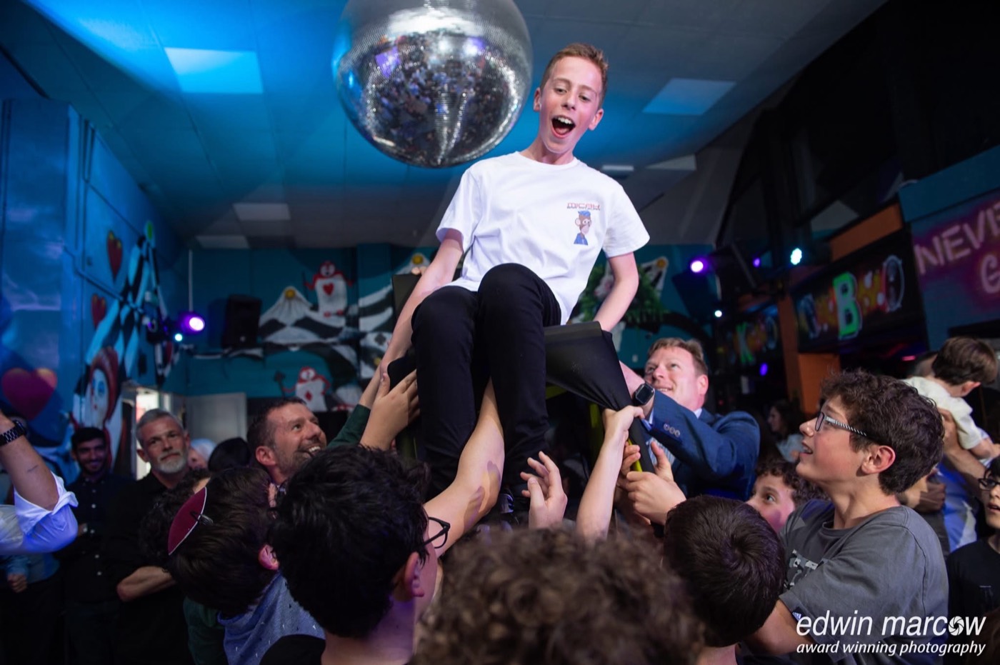 The Bar Mitzvah boy lifted on a chair during the hora